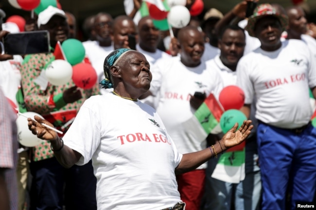 A supporter of Burundi's ruling party, the National Council for the Defense of Democracy-Forces for the Defense of Democracy (CNDD-FDD), dances during their final rally ahead of the referendum in Bujumbura, Burundi, May 14, 2018.