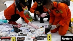 Rescue workers lay out recovered belongings believed to be from the crashed Lion Air flight JT610 at Tanjung Priok port in Jakarta, Indonesia, October 30, 2018. 