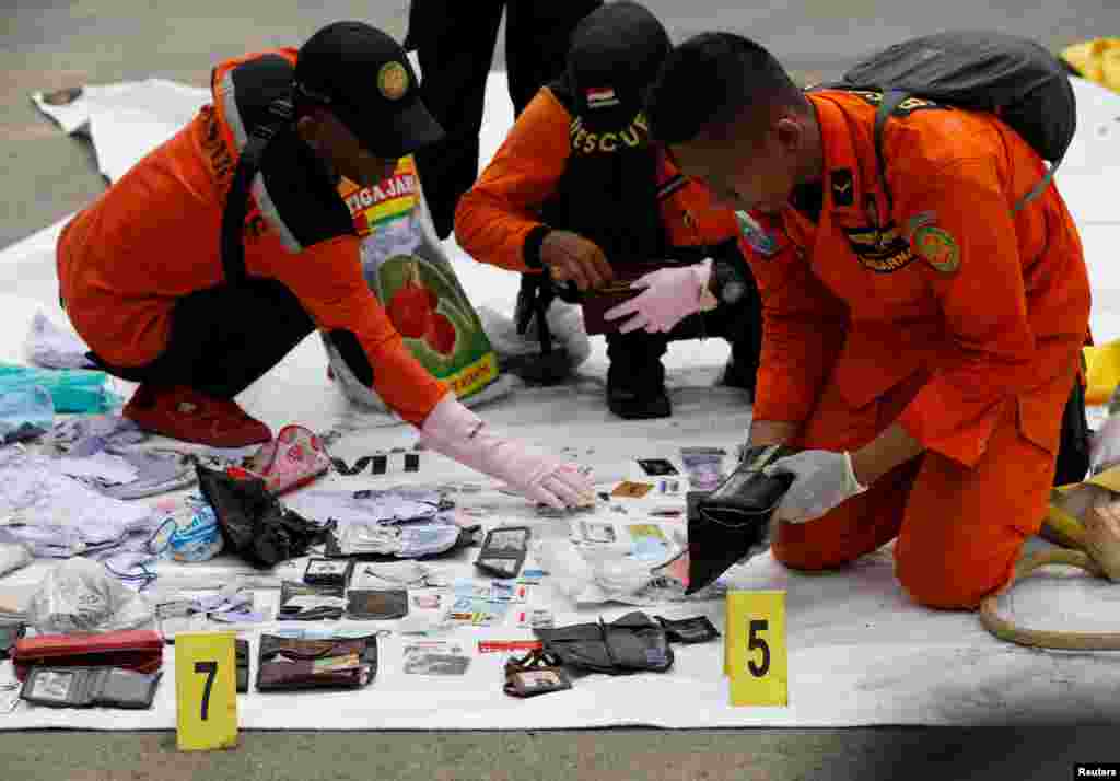 Rescue workers lay out recovered belongings believed to be from the crashed Lion Air flight JT610 at Tanjung Priok port in Jakarta, Indonesia.