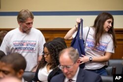 FILE - People in support of statehood for the District of Columbia arrive on Capitol Hill in Washington for a House panel's hearing on whether the district's government truly has the power to spend local tax dollars without approval by Congress, May 12, 2016.