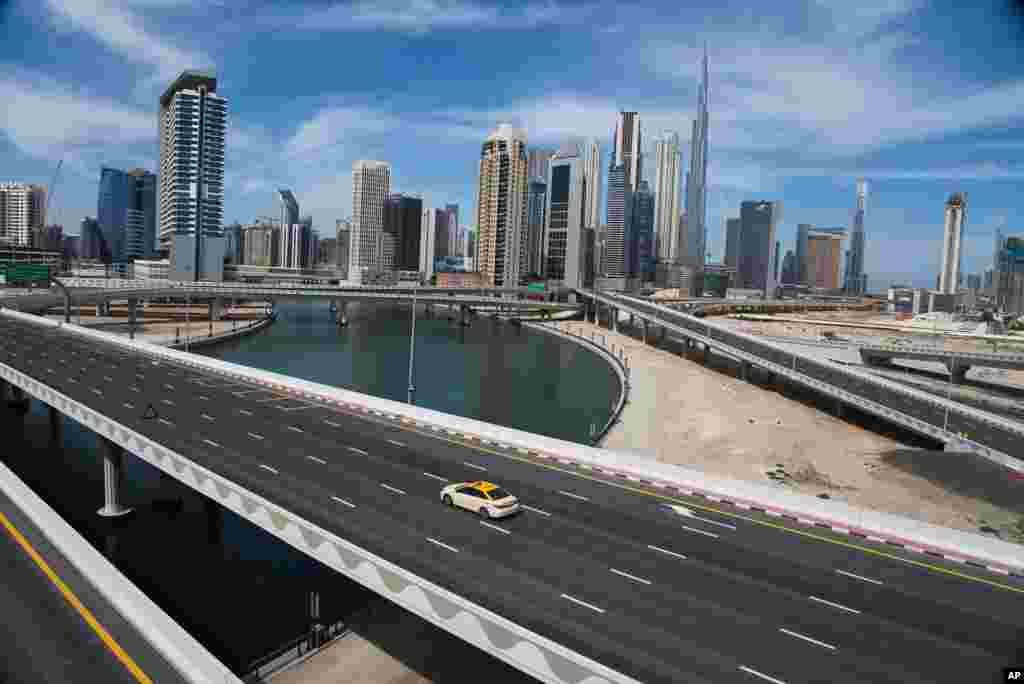 A lone taxi cab drives over a typically gridlocked highway in Dubai, United Arab Emirates. Dubai is now under a 24-hour lockdown over the new coronavirus pandemic.