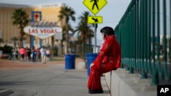 Ted Payne rests as he works for tips dressed as Elvis at the "Welcome to Las Vegas" sign in Las Vegas, March 3, 2016.