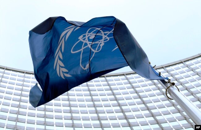 FILE - The flag of the International Atomic Energy Agency (IAEA) flies in front of the Vienna headquarters at the Vienna International Center, March 27, 2009.