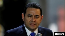 FILE - Guatemala's President Jimmy Morales speaks to the media after his arrival at Mariscal Sucre Airport in Quito, Ecuador, May 23, 2017, ahead of Ecuadorean presidential inauguration. 