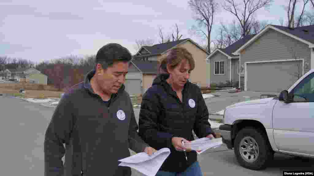 Joe Enriquez Henry with the League of United Latin American Citizens goes door-to-door to urge people to vote in Des Moines, Iowa. Iowa's first-in-the-nation caucuses kick off the U.S. primary election season Monday.