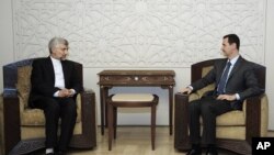 Iran's Supreme National Security Council, Saeed Jalili, meets with Syrian President Bashar Assad in Damascus, Syria, Aug. 7, 2012. (SANA)