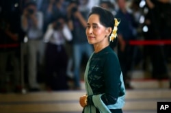 FILE - In this March 15, 2016 file photo, National League for Democracy party (NLD) leader Aung San Suu Kyi arrives in Manama's parliament in Naypyitaw, Myanmar.