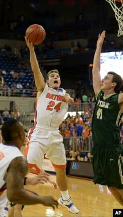 Florida guard Zach Hodskins (24) goes for two points with William & Mary forward Jack Whitman (41) trying to block his shot during the second half of NCAA College basketball in Gainesville, FL, Friday, Nov., 14, 2014.