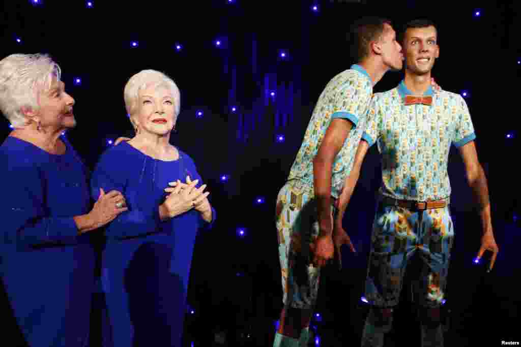 French singer and actress Line Renaud (L) and Belgian singer Stromae stand next to their figures at the Grevin wax museum in Paris, France, Oct. 12, 2014.
