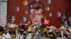 Tributes lie placed around a mural of British singer David Bowie by artist Jimmy C in Brixton, south London, Thursday, Jan. 14, 2016. 