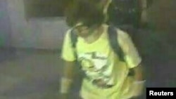 A man wearing a yellow T-shirt and carrying a backpack is seen walking near the Erawan shrine, where a bomb blast killed 22 people on Monday, in Bangkok, Thailand in this handout still image taken from closed-circuit television (CCTV) footage, released by the Thai Police on August 18, 2015.