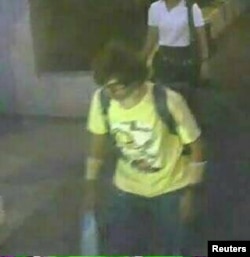 A man wearing a yellow T-shirt and carrying a backpack is seen walking near the Erawan shrine, where a bomb blast killed 22 people on Monday, in Bangkok, Thailand in this handout still image taken from closed-circuit television (CCTV) footage, released by