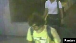A man wearing a yellow T-shirt and carrying a backpack is seen walking near the Erawan shrine, where a bomb blast killed 22 people on Monday, in Bangkok, Thailand in this handout still image taken from closed-circuit television (CCTV) footage.