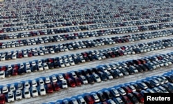 New cars are seen at a parking lot in Shenyang, Liaoning province, China, Jan. 16, 2017.