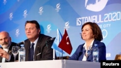 Hasan Arat, Bid Chairman and Vice President of the Turkish National Olympic Committee, Alp Berker (L), Director of Sport at Istanbul 2020, Nese Gundogan (R), Secretary General of Turkey's National Olympic Committee give a news conference in Buenos Aires,