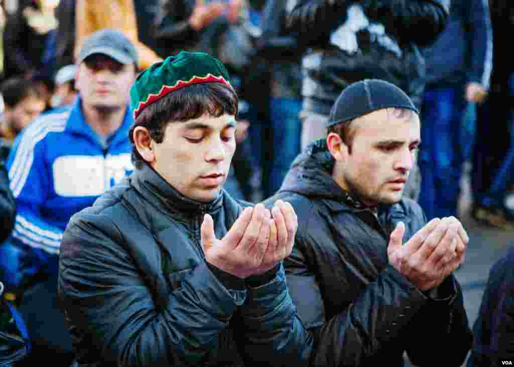 Men complete their prayers on a closed street, Moscow, Oct. 15, 2013. (Vera Undritz for VOA)