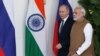 FILE - Russian President Vladimir Putin and India's Prime Minister Narendra Modi arrive ahead of their meeting at Hyderabad House in New Delhi, India, Oct. 5, 2018.