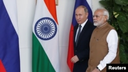 FILE - Russian President Vladimir Putin and India's Prime Minister Narendra Modi arrive ahead of their meeting at Hyderabad House in New Delhi, India, Oct. 5, 2018.