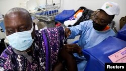 FILE PHOTO: An Ivorian traditional chief receives a vaccine against the coronavirus disease (COVID-19) in a vaccination truck during the visit of Sandra Kramer, director for Africa at the Directorate General for International Partnerships (INTPA) of the European Commission, and M