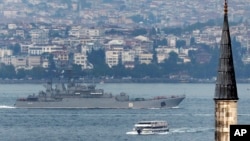 FILE - A Russian warship passes through the Bosphorus, in Istanbul, en route to the Mediterranean Sea, Oct. 6, 2015. 
