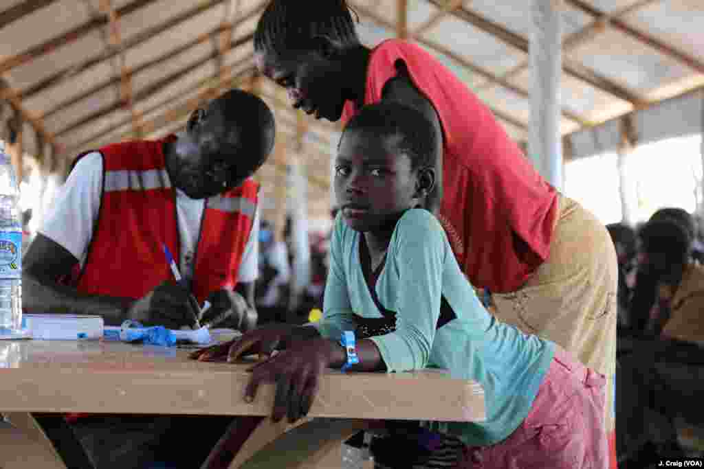 South Sudanese girl waits for her mother to finalize their paperwork in the Imvepi refugee settlement’s processing center. Photo taken on March 31 in Arua, Uganda.