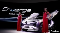 Models pose with the GAC Enverge electric concept car at the North American International Auto Show in Detroit, Michigan, Jan. 15, 2018.