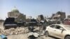 FILE - Much of the Old City of Mosul lay in ruins as Iraqi forces battled Islamic State militants for the city. The destroyed al-Nuri mosque, in the background, illustrated the level of destruction in the city, July 1, 2017.