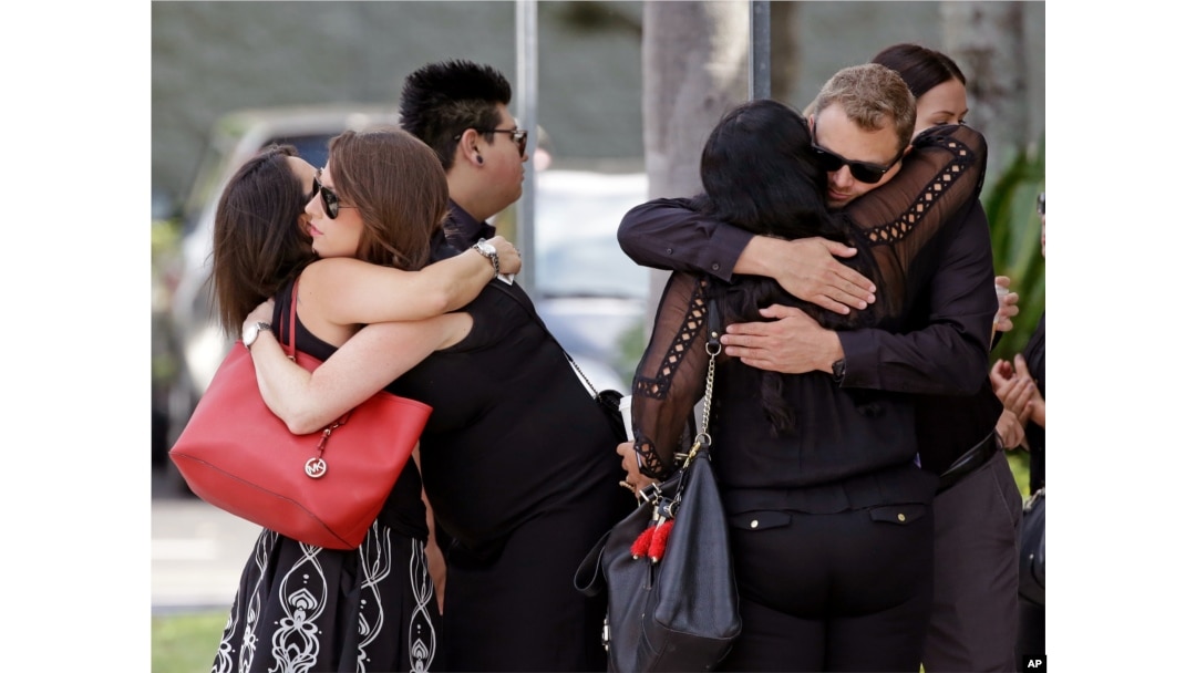 Mourners embrace outside the funeral service for Anthony Luis Laureano Disla, one of the victims of the Pulse nightclub mass shooting in Orlando, Florida, June 17, 2016.