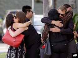Mourners embrace outside the funeral service for Anthony Luis Laureano Disla, one of the victims of the Pulse nightclub mass shooting in Orlando, Florida, June 17, 2016.