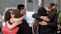 Mourners embrace outside the funeral service for Anthony Luis Laureano Disla, one of the victims of the Pulse nightclub mass shooting, Friday, June 17, 2016, in Orlando, Fla. (AP Photo/John Raoux)