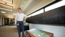 Adam Jokerst shows the pipe that used to carry water to the community but now makes up a display in the water department in Greeley, Colo. (AP Photo/David Zalubowski)