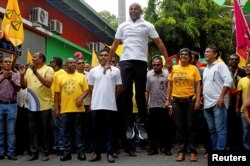 Ibrahim Mohamed Solih, the Maldivian presidential candidate backed by the opposition coalition, jumps next to his supporters during the final campaign rally ahead of the presidential election in Male, Maldives, Sept. 22, 2018.