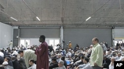 French Muslims attend a mass prayer at a prayer hall in a unused former fire station, Paris, September 16, 2011.