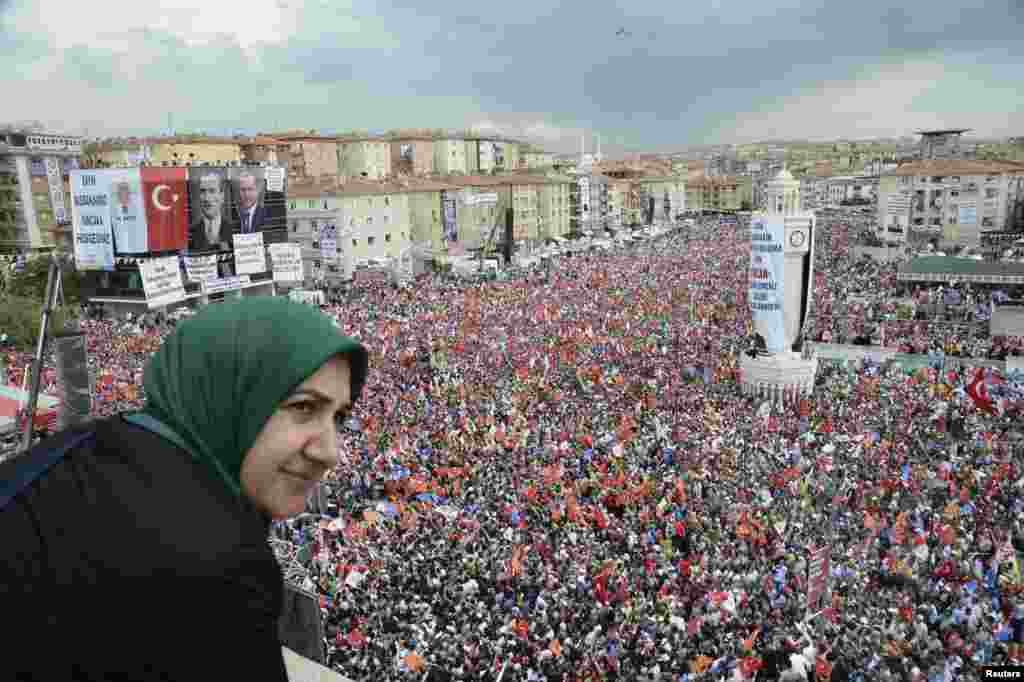 A supporter of Turkey's Prime Minister Tayyip Erdogan watches a rally organized by the ruling Justice and Development Party in Ankara, June 15, 2013. 
