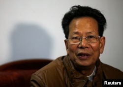 FILE - Lin Zulian talks to journalists after being elected as village chief in Wukan village, Guangdong province, March 31, 2014.