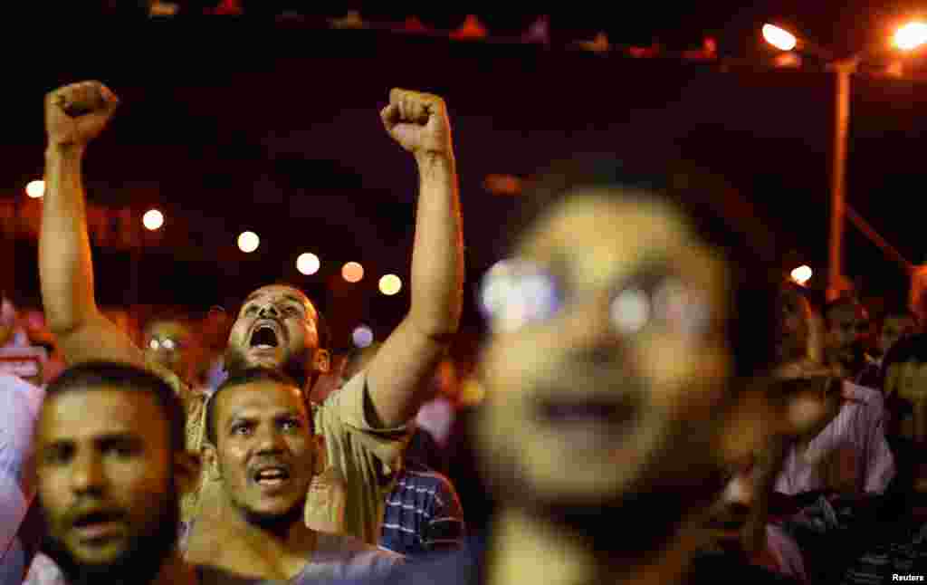 Supporters of the ousted Egyptian President Mohamed Morsi shout anti-army slogans during a sit-in protest in Cairo July 11, 2013. 