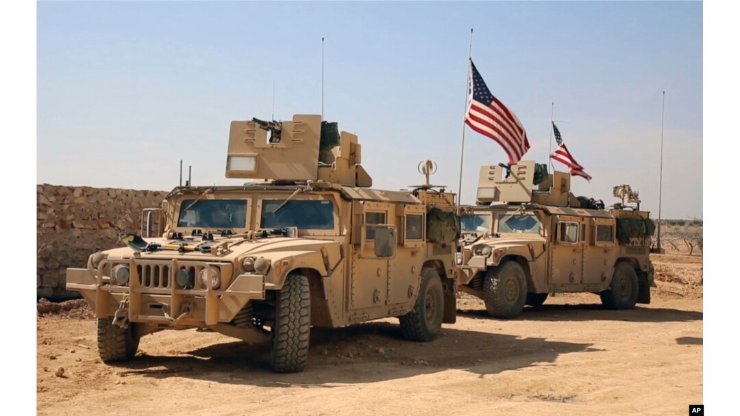 FILE - U.S. forces take up positions on the outskirts of the Syrian town, Manbij, a flashpoint between Turkish troops and allied Syrian fighters and U.S.-backed Kurdish fighters, March 7, 2017.