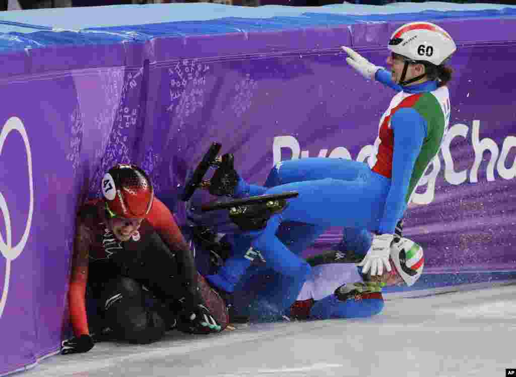 Italy&#39;s Lucia Peretti and Cecilia Maffei collide with Canada&#39;s Valerie Maltais during their women&#39;s 3000 meters short track speedskating relay A final in the Gangneung Ice Arena at the 2018 Winter Olympics in Gangneung, South Korea, Feb. 20, 2018.