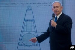 Israeli Prime Minister Benjamin Netanyahu presents material on Iranian nuclear weapons development during a press conference in Tel Aviv, April 30, 2018.