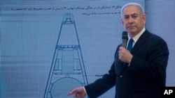 Israeli Prime Minister Benjamin Netanyahu presents material on Iranian nuclear weapons development during a press conference in Tel Aviv, April 30 2018.