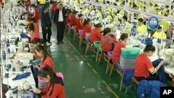 FILE - In this file image from undated video footage run by China's CCTV via AP Video, Muslim trainees work in a garment factory at the Hotan Vocational Education and Training Center in Hotan, Xinjiang, northwest China.