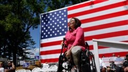 FILE - Democratic Rep. Tammy Duckworth, an Iraq War veteran who lost both of her legs in combat, acknowledges applause from supporters during a rally in Springfield, Illilois, Aug. 20, 2015. Some polls show ahead in her quest to unseat incumbent Republica