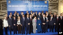 Italian Foreign Minister Franco Frattini, center, poses with the other delegates during a group photo following a meeting on how to support rebels fighting the Libyan leader Moammar Gadhafi, at Rome's Foreign Ministry, May 5, 2011