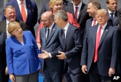 FILE - (L-R) German Chancellor Angela Merkel, Belgian Prime Minister Charles Michel, NATO Secretary-General Jens Stoltenberg and U.S. President Donald Trump, watch a fly-by during a summit of heads of state and government at NATO headquarters in Brussels.