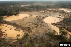 FILE - An area deforested by illegal gold mining is seen in a zone known as Mega 13, at the southern Amazon region of Madre de Dios, Peru, Jan. 25, 2014.