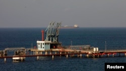 FILE - A view of pipelines and a loading berth of the Hariga oil port in the city of Tobruk, east of Tripoli, Libya.