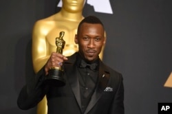 Mahershala Ali poses in the press room with the award for best actor in a supporting role for "Moonlight" at the Oscars on Feb. 26, 2017, at the Dolby Theatre in Los Angeles.