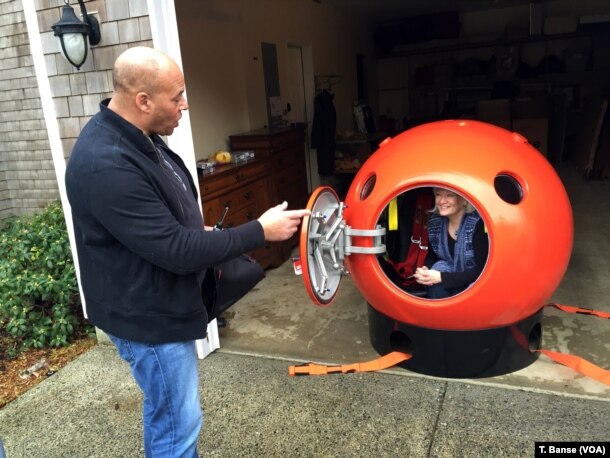 Survival Capsule President Julian Sharpe gives some tips to his first U.S. customer, Jeanne Johnson.