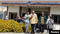 Unidentified relatives and friends of passengers flying in an EgyptAir plane that vanished from radar en route from Paris to Cairo wait outside the EgyptAir in-flight service building at Cairo International Airport, Egypt, May 19, 2016.