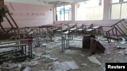 Damaged desks and benches are seen at a school which activists said was damaged by shelling by forces loyal to Syria's President Bashar al-Assad, in Deraa April 10, 2013.